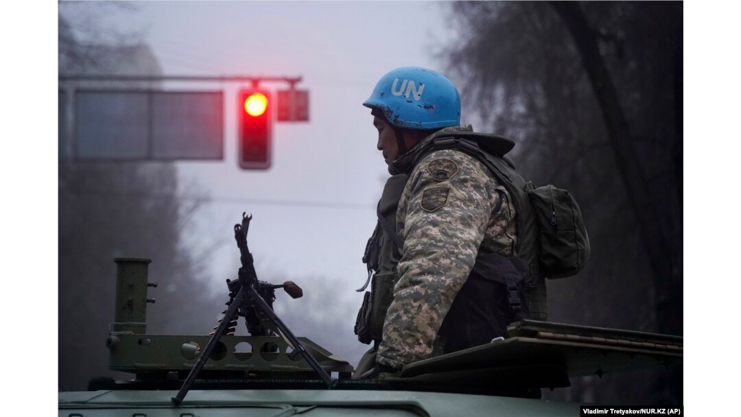 A Kazakh soldier stands near a belt-fed machine gun in Almaty on January 6. The images from Almaty in this story were released by AP on January 8.