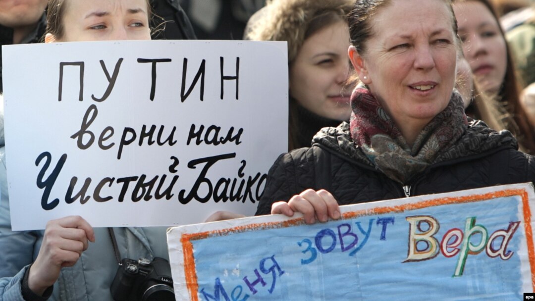 A woman holds a poster reading "Putin, give us a clean Baikal back" at a demonstration in Moscow in March.