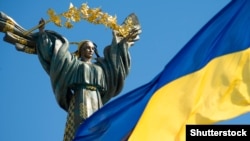 Прапор України на фоні монументу Незалежності у Києві