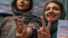 Iran -- Iranian women show their ink-stained fingers after casting their votes during the presidential election in Tehran, May 19, 2017