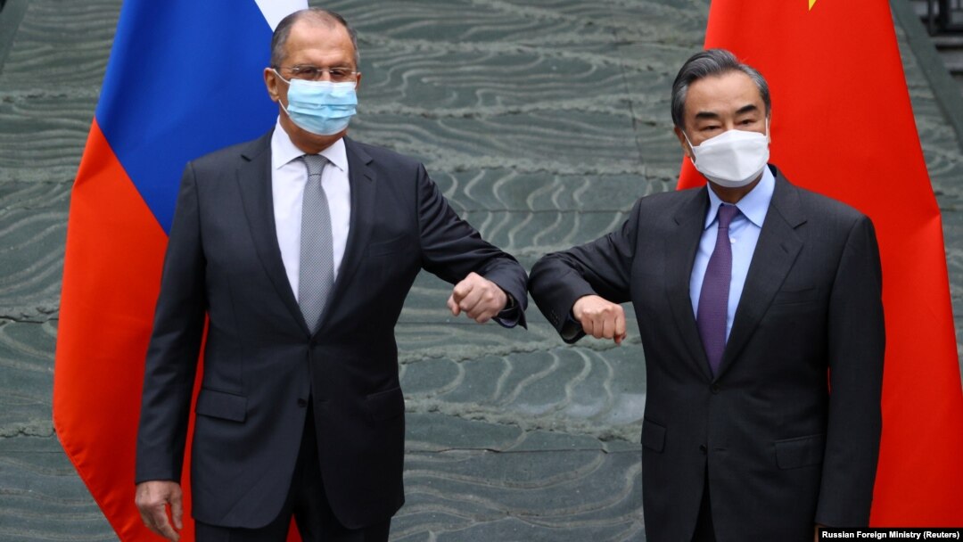 Russian Foreign Minister Sergei Lavrov (left) and his Chinese counterpart, Wang Yi, pose for a picture during a meeting in China on March 22.