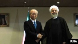 حسن روحانی، رییس جمهوری ایران، و یوکیا آمانو، مدیرکل آژانس بین المللی انرژی اتمی