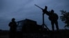 FILE PHOTO: Members of a mobile air defence volunteer unit stand next to their machine gun during the most massive Russian drone attack in Kyiv region