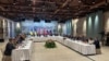 This handout photograph taken and released by Ukrainian Foreign Ministry on May 16, 2025, shows members of Ukrainian (L) and Russian (R) delegations attending a meeting at the Turkish Presidential office Dolmabahce, in Istanbul.